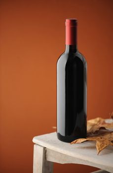 red wine bottle on a white wooden chair