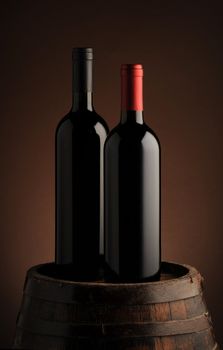 red wine bottle on wodden barrel