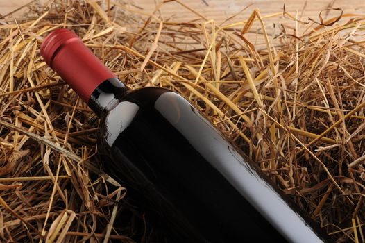 wine bottle on a straw background