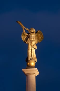 Statue of an angel at Uzupio, a bohemian and artistic district in Vilnius, Lithuania. Night photo.