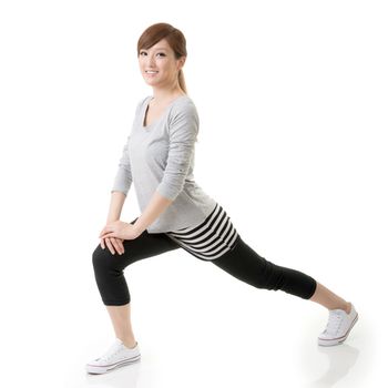 Fitness Asian girl doing stretch exercise, full length portrait isolated on white background.