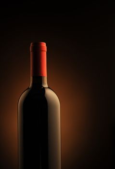 red wine bottle , red light on background