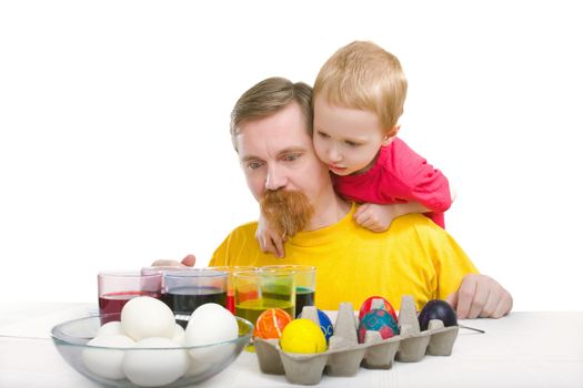 Man and boy look at paint and eggs