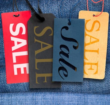 Tags With Sale Sign With Stack of Blue Jeans in Background