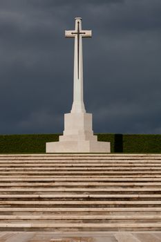 Large marble cross with a sword decoration at a war grave cemetery