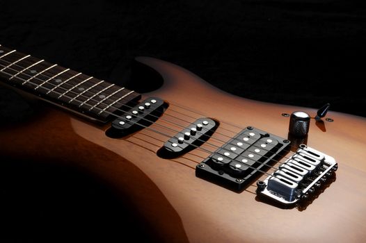  close up of a electric guitar on dark background