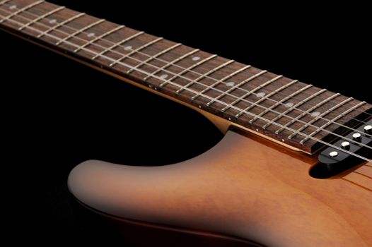  close up of a electric guitar on dark background