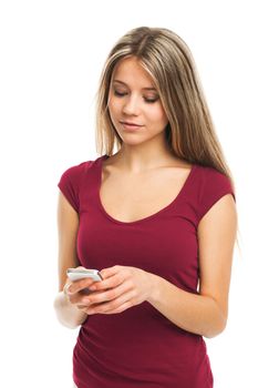 Beautiful girl writing a message on her phone, on white