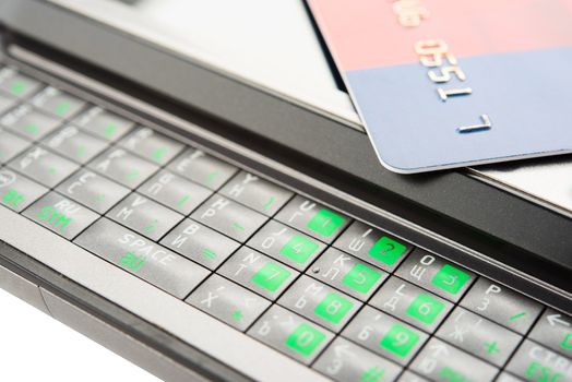 Close view of smartphone with credit card.