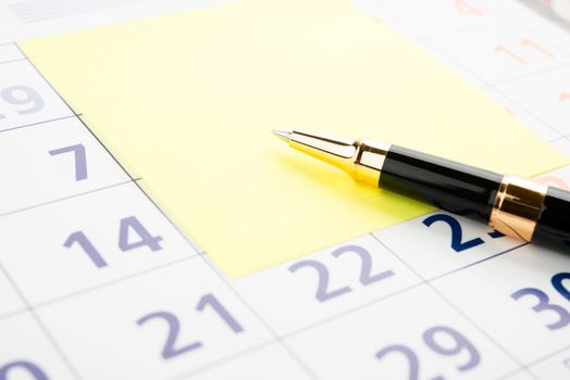 Closeup of a sticky note on a calendar