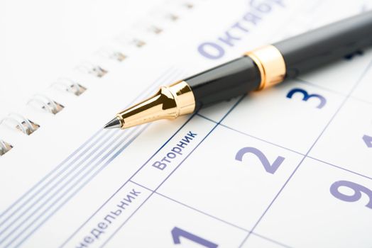 Setting a date. Calendar and pen.