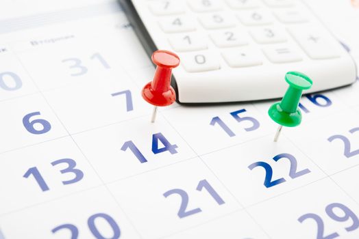 push pin in calendar with calculator