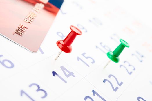 push pin in calendar with credit card