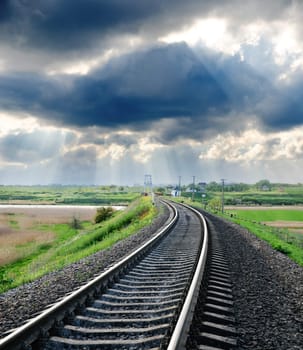 railroad to horizon under cloudy sky