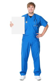 Male doctor / nurse showing billboard sign. Young medical professional wearing blue scrubs and stethoscope standing in full body isolated on white background.