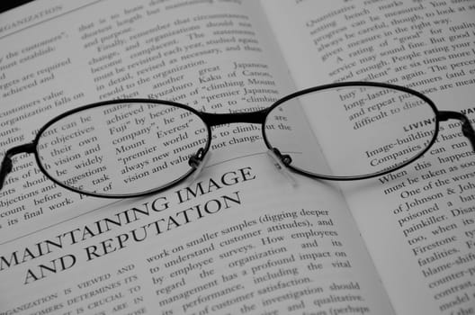 Image of reading glasses on an open page