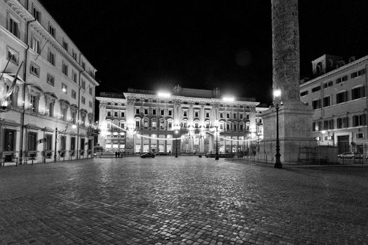 An empty and deserted cobble stone piazza in Rome at night.