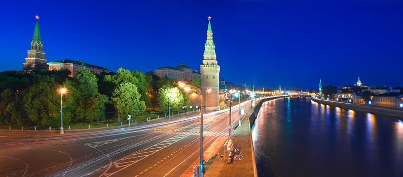 Kremlin embankment of the Moskva River and the Vodovzvodnaya (Water) Tower of the Moscow Kremlin at night. Shot from the Big Stone Bridge. Moscow, Russia.