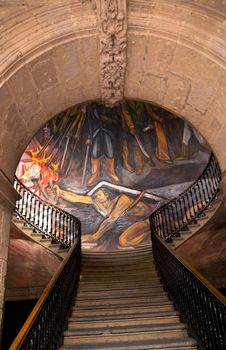 Stairs in Government Palace Morelia Mexico.  Facing Mural by Alfredo Zalce of War of Independence in Mexico when Mexican Peasant, later known as the Turtle, La Pipila, braved Spanish gunfire to blow up Fort