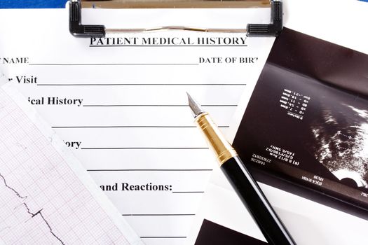Document showing medical history, stethoscope and a pen