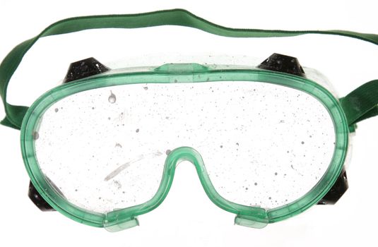 Goggles with paint drips on the lens.
