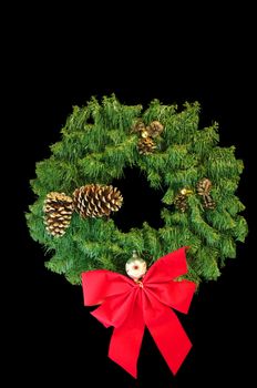 A Green Christmas wreath with a red bow