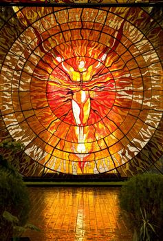 Cosmovitral Botanical Garden in Toluca Mexico is surrounded by stained glass.  This is Sun Man.