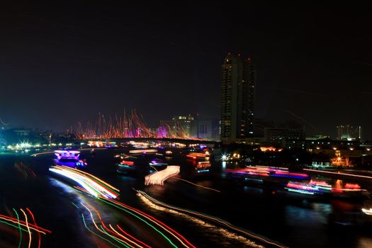 Colorful river with light trail from ship over Chao Phraya River on Father's Day in Thailand