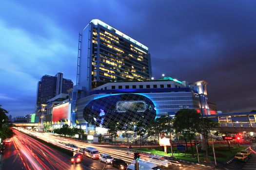 Bangkok famous and fashion shopping Center building at night with traffic light trail