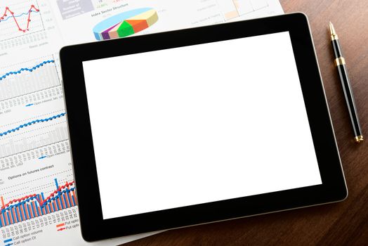 Tablet computer with blank screen on a businessman workplace