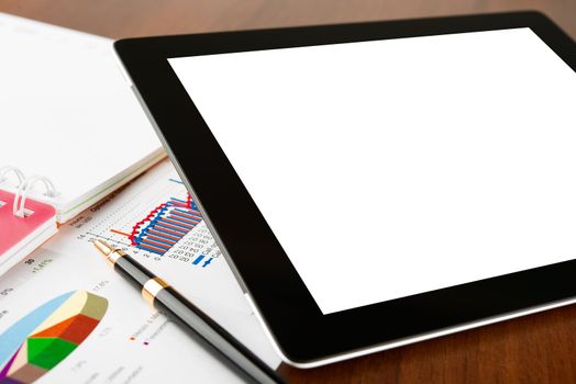 Tablet computer with blank screen on a businessman workplace