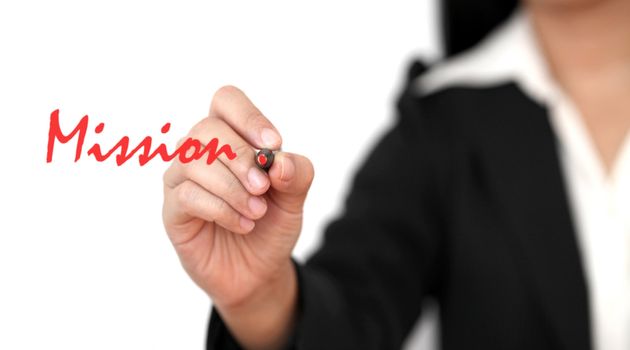 asian business woman hand writing Mission word