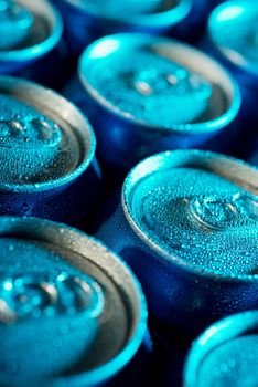 Ice cold cans under blueish light closeup