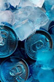 Soda tin cans with condensation and under ice