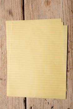 Yellow memopaper sheets on two wooden planks