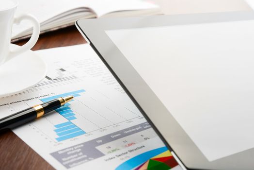 Tablet computer with blank screen on a businessman workplace