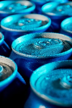 Aluminium beverage cans under cold light closeup