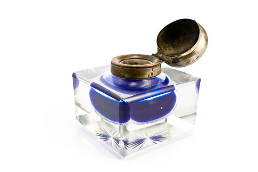 Antique inkwell with blue ink isolated on white