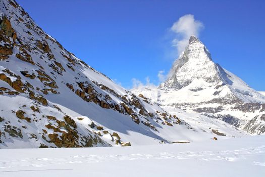Matterhorn Peak in Swiss Alps with red rock landscape