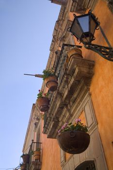Orange Adobe Wall Balconies, Flowers, Water Spouts, Queretaro, Mexico
