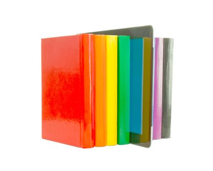 Row of colorful books and electronic book reader over white background