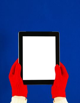 Hands wearing red gloves holding a tablet PC