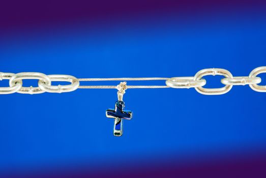 Broken chain connected with a cross - metaphor of Christ's salvation