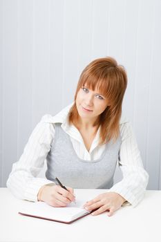 Attractive girl with a notepad and pen