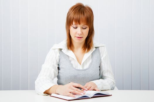 Attractive girl with a notepad and pen