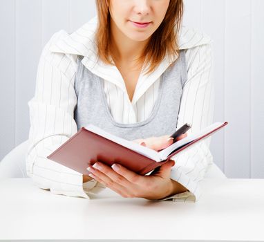 Business woman with notebook in the office
