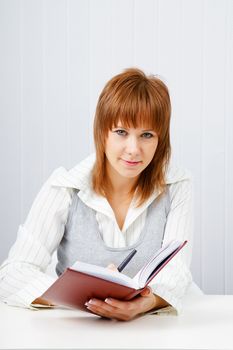 Attractive girl with a notepad and pen