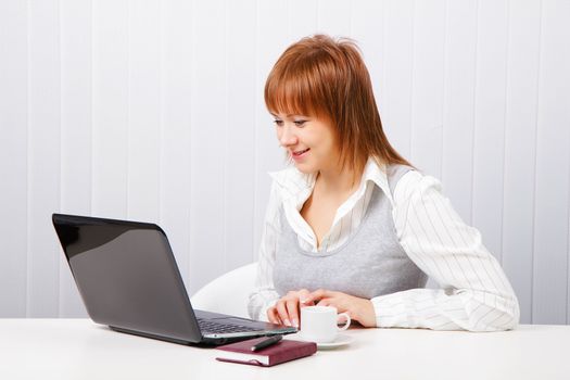 smiling attractive girl with a notebook. Office worker