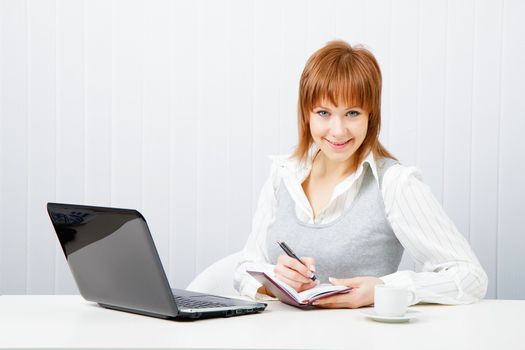 smiling attractive girl with a notebook. Office worker