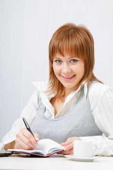 smiling attractive girl with a notebook. Office worker